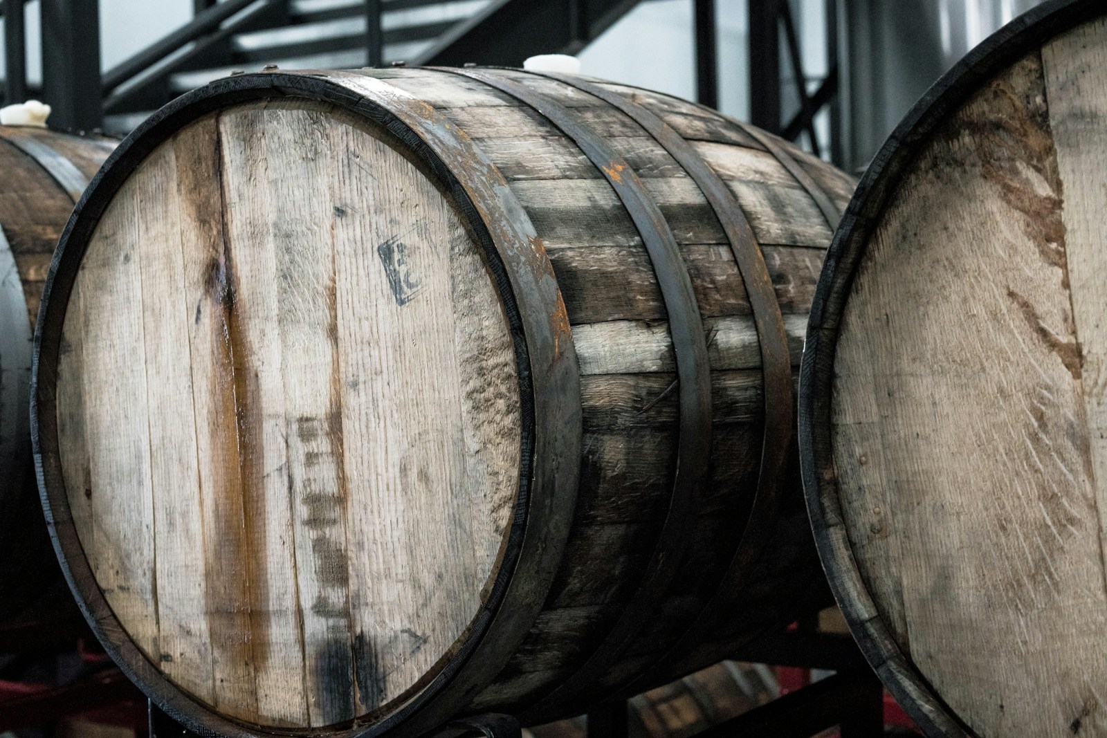 Close-up of a single oak whisky barrel showing its wood grain and metal hoops